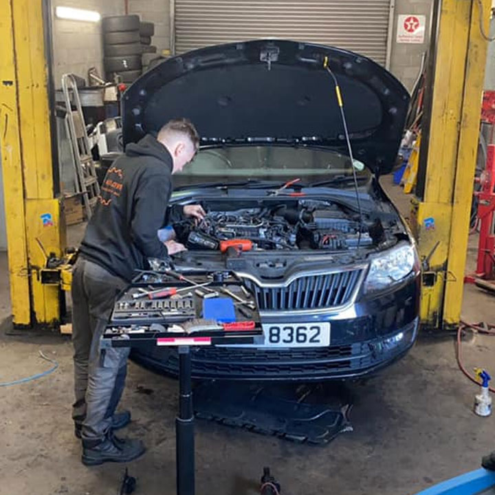 J&M Auto Repairs mechanic repairing engine